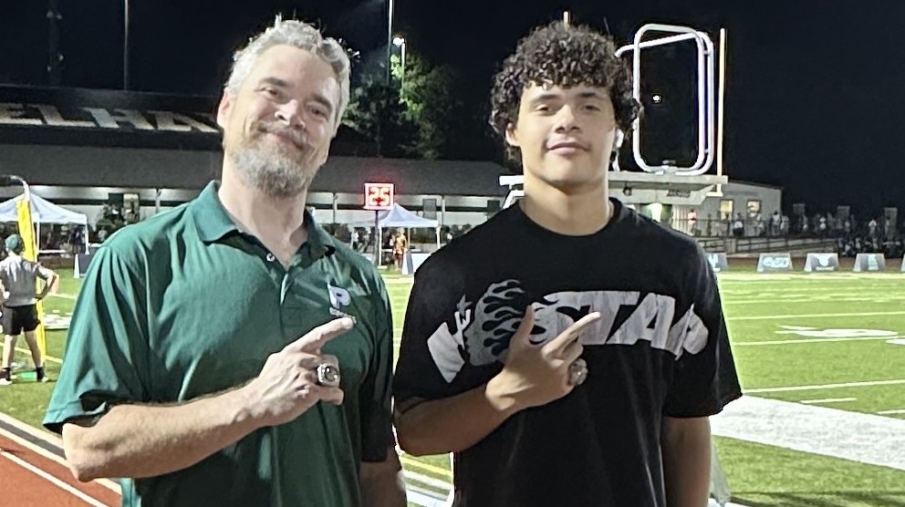Spencer Stone coaching at the stadium with a student