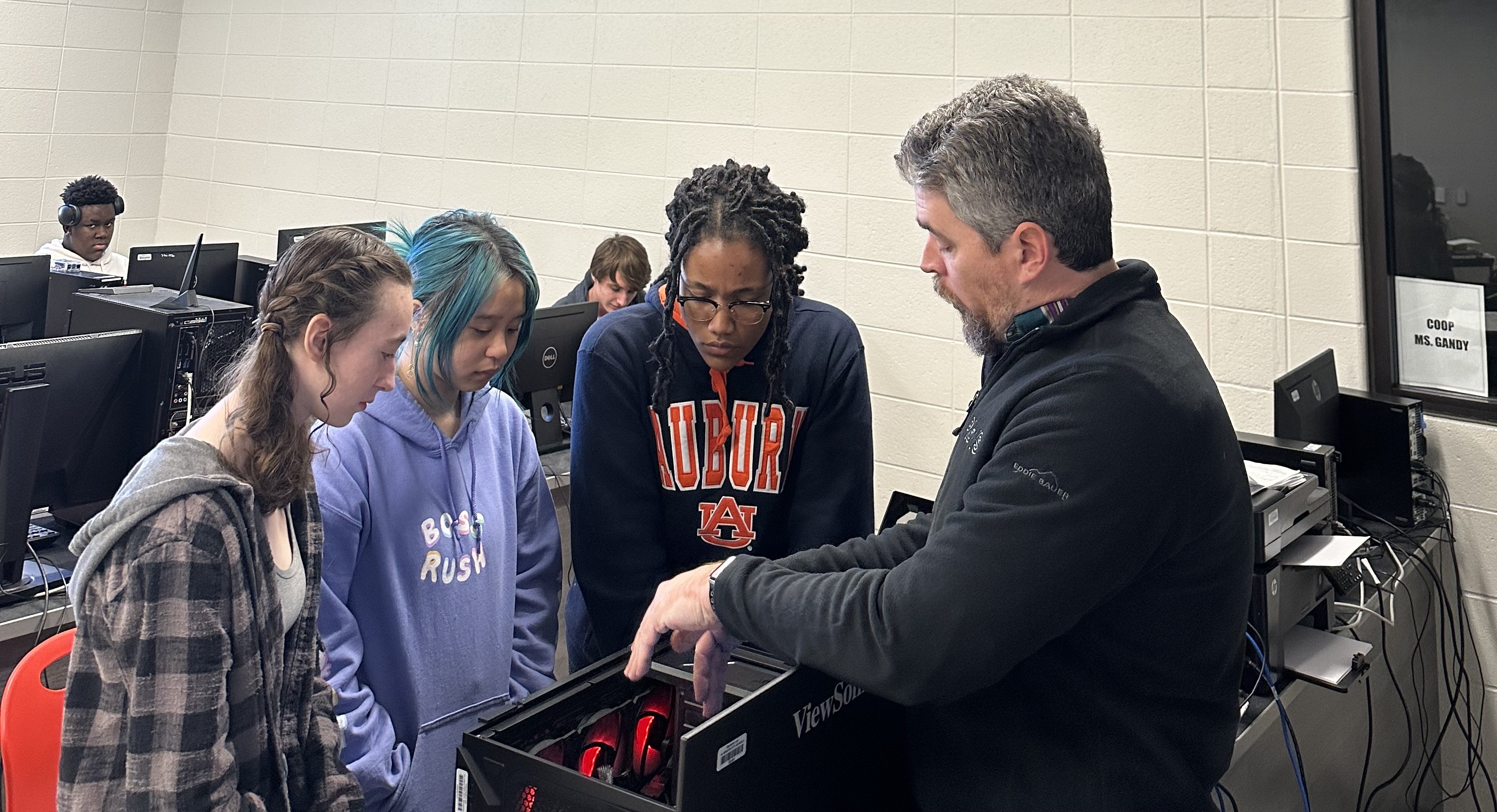Spencer Stone working hands-on with a student on a computer